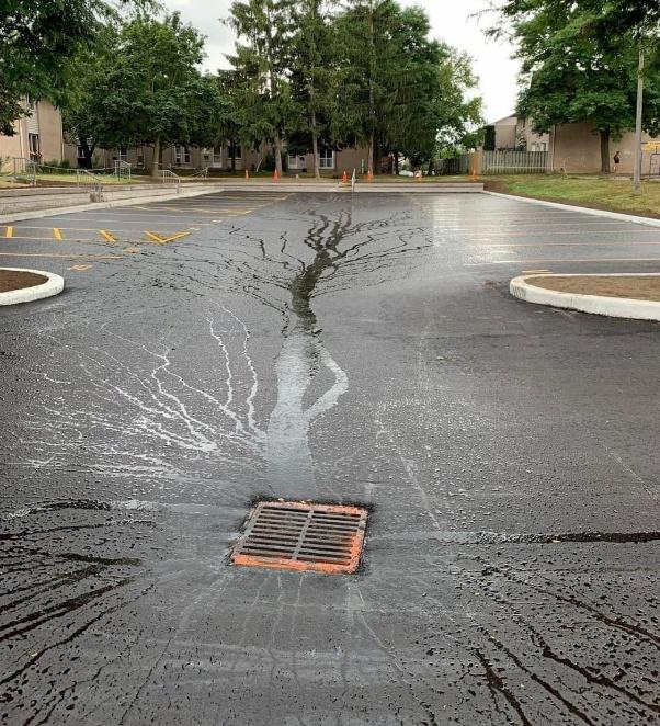 Commercial parking lot inspection showing drainage and damaged pavement before parking lot asphalt repair in California.