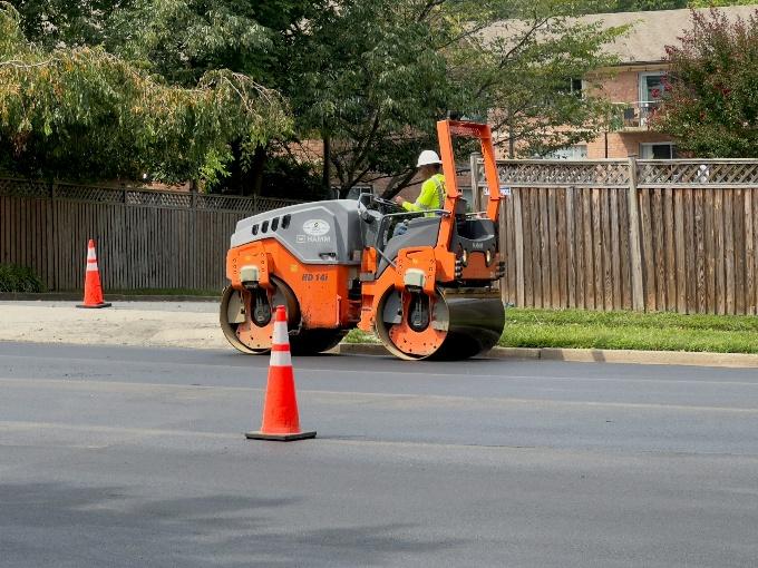 Asphalt roller compacting pavement for commercial California pavement services
